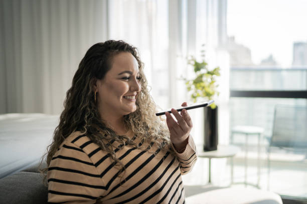 istock Woman sending audio message on smartphone at home 1333805896