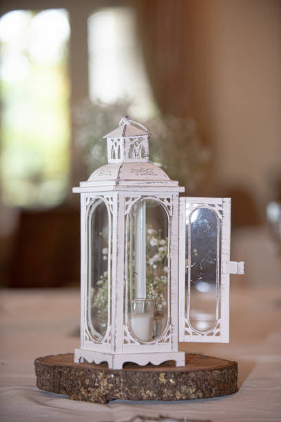 istock White antique candle lantern centerpiece at wedding reception dinner setting 1333807943