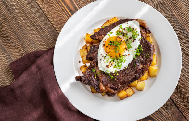 Beefsteak with fried egg Beefsteak with fried egg and potato flat lay steak and eggs breakfast stock pictures, royalty-free photos & images