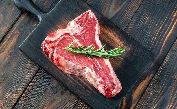 istock Raw T-bone steak with fresh rosemary 1333808097