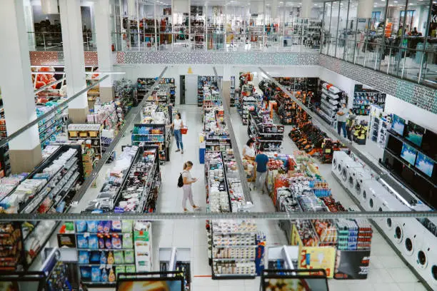 Overhead image of people buying in the large supermarket.