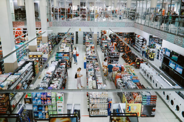 overhead image of people buying in the large supermarket - loja imagens e fotografias de stock