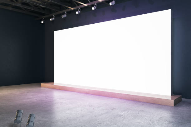 istock Illuminated blank white billboard in interior with concrete flooring and mock up place for your advertisement. 3D Rendering. 1333809896