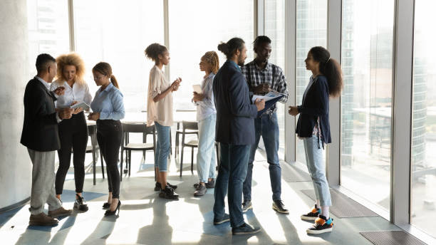 istock Motivated african american colleagues talking in small groups. 1333810598