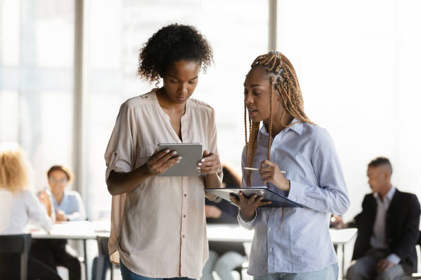istock Focused young african employees discussing online project. 1333810624