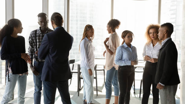 istock Young african american business people talking in small groups. 1333810627