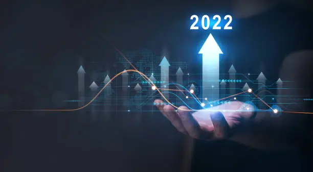 Photo of Businessman holding growth graph with year 2022. 
Corporate future growth plan in new year 2022.Development to success and growth business concept.