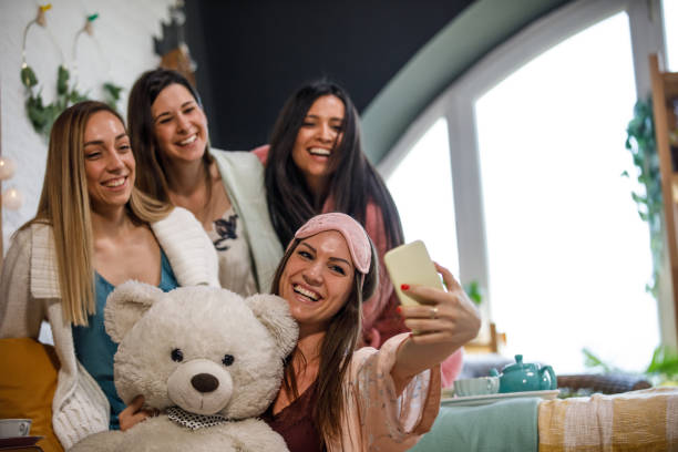 istock Copy space shot of four girlfriends taking a group selfie with a teddy bear 1333812545