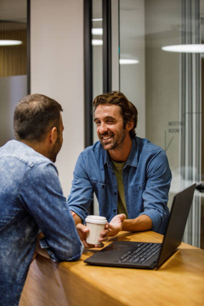 istock Two casual businessmen chatting during coffee break 1333812608