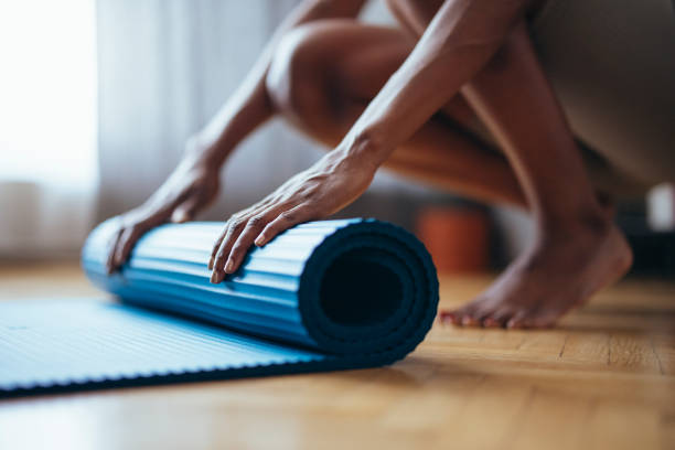 istock An Anonymous Fitness Woman Folding Blue Exercise Mat 1333812746
