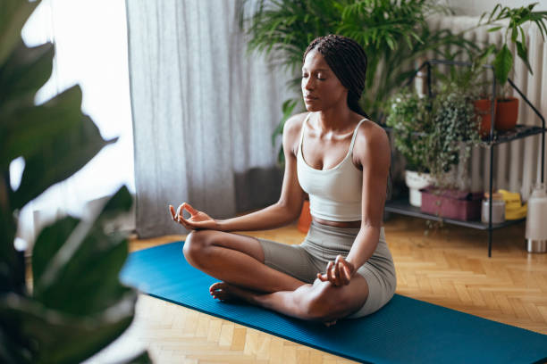istock Beautiful Woman Meditating at Home 1333812758