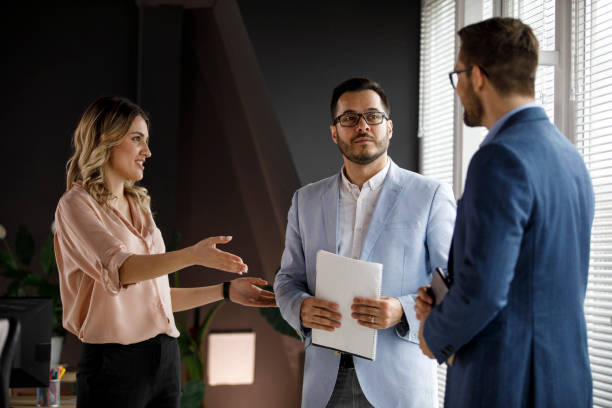 istock Three business colleagues standing in the office, casually chatting 1333813268