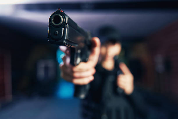istock Professional sniper leveling the handgun at a target 1333814611