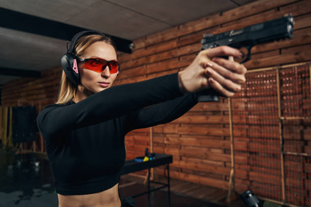 istock Focused pretty lady aiming at a target 1333814650