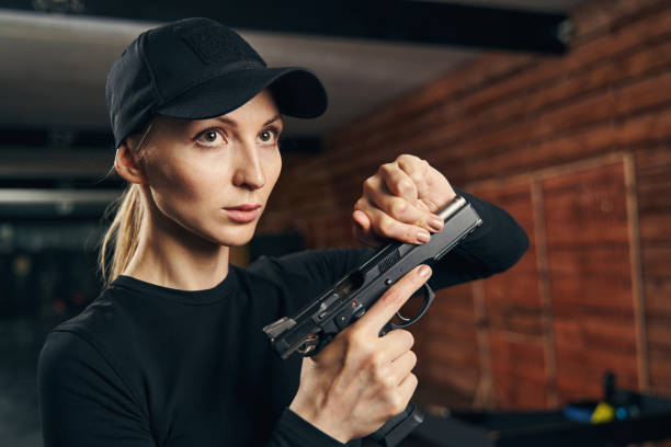 istock Beautiful Caucasian blonde lady reloading her gun 1333814669
