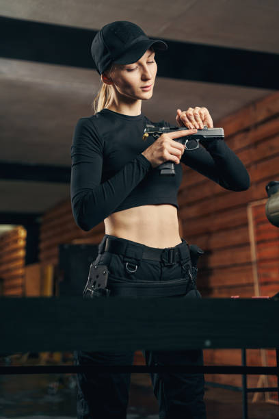 istock Serious woman focused on reloading her handgun 1333814683