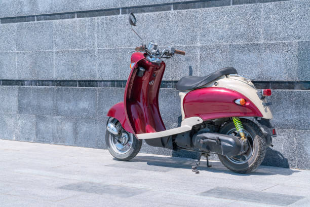 istock a red scooter standing against a stone wall 1333814794