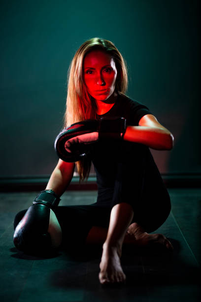 Kick boxer woman in dark concept.