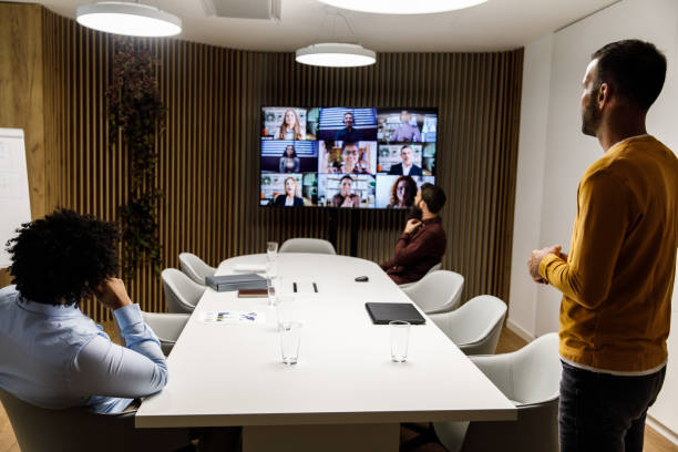 istock Three businessmen talking with their colleagues over a group video conference 1333816303
