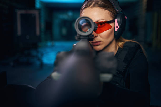 istock Serious woman using a telescopic sight mounted on the weapon 1333817320