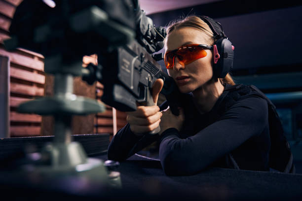 istock Serious woman using a telescopic sight for target shooting 1333817323
