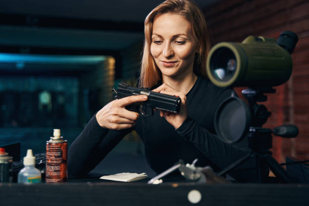 istock Professional female shooter focused on inspecting her handgun 1333817364