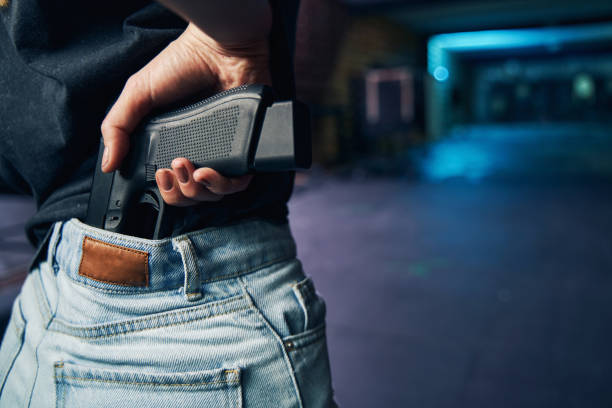 istock Experienced policewoman hiding her firearm in her trousers 1333817469