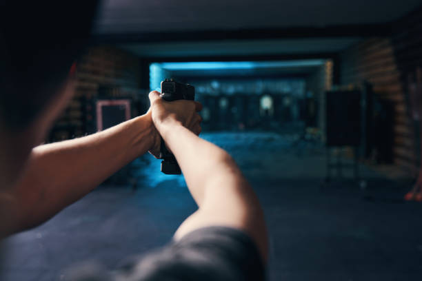 istock Female shooter mastering a two-handed hold during the shooting drill 1333817471
