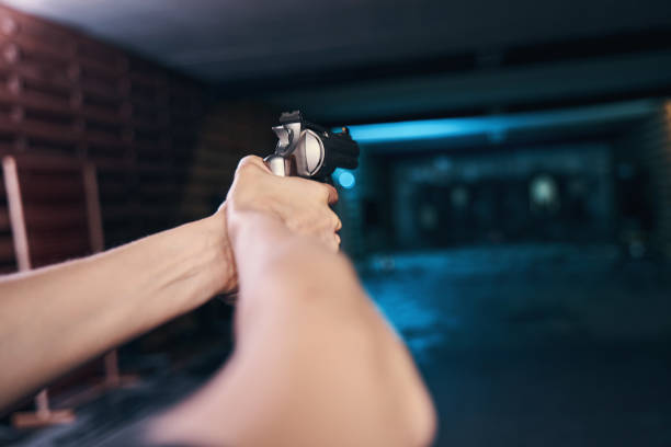 istock Adult man aiming his pistol at a target 1333817474