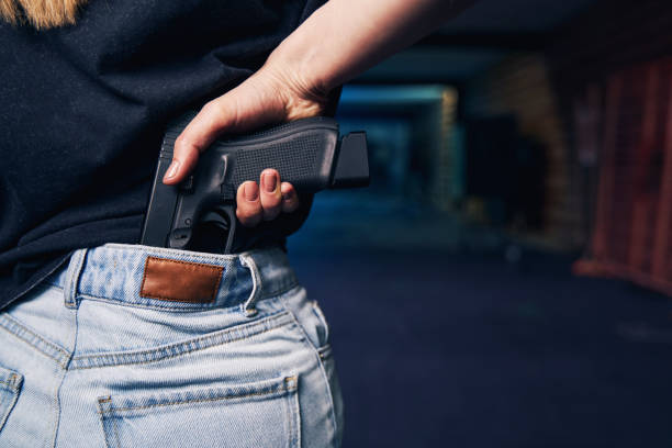 istock Woman hiding her weapon in her jeans 1333817476