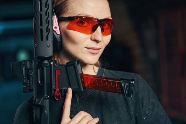 istock Beautiful lady in protective eyewear holding a weapon with one hand 1333817487