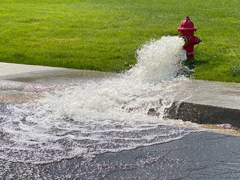 Fire hydrant with water pouring into the street