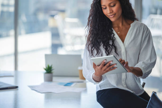 istock Young business woman using a digital tablet. 1333820975