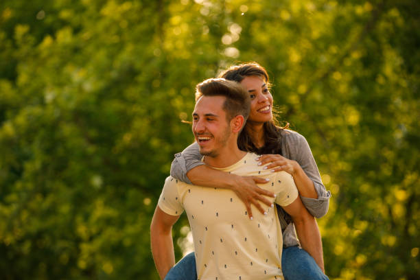 istock Young man carrying his girlfriend on the back while they are enjoying a park walk 1333821214