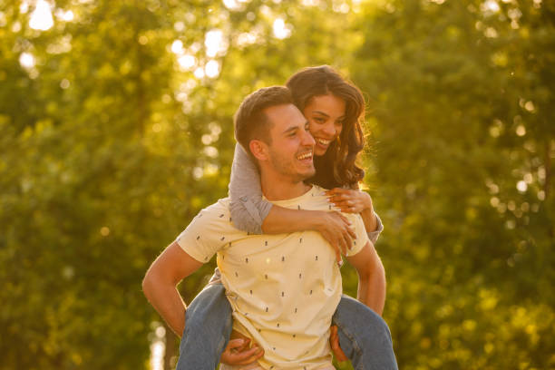 istock Happy young man carrying his girlfriend on the back during their date 1333821216