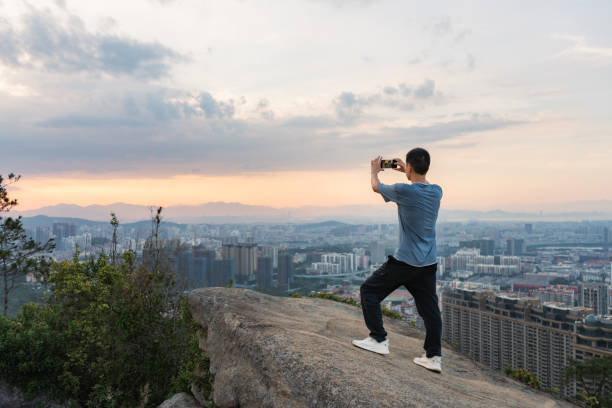 istock Asian man takes a selfie on the rock after climbing successfully 1333821976