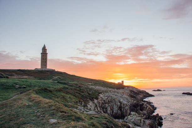 General view of the Tower of Hercules located in Coruna - Galicia - Spain in a sunset General view of the Tower of Hercules located in Coruna, Galicia, Spain in a sunset. Concept of travel. a coruna province stock pictures, royalty-free photos & images