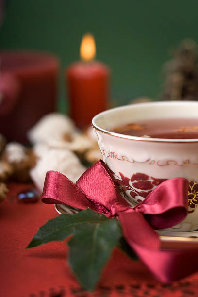 hot cup of tea with ribbon, cookies and candle stock photo