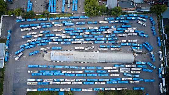 Top down aerial view directly above the abandoned trolley buses in a bus fleet or bus parking