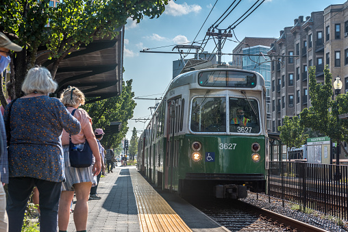 Boston Massachusetts, United States - August 6, 2021: View of passengers waiting for the green line train approaching the Museum of Fine Arts station, in Boston.