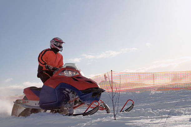 istock Man snowmobiling in an isolated snowy field 133383299