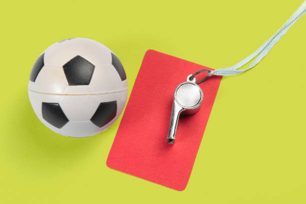 istock Soccer ball, yellow and red cards and referee whistle. 1333834052
