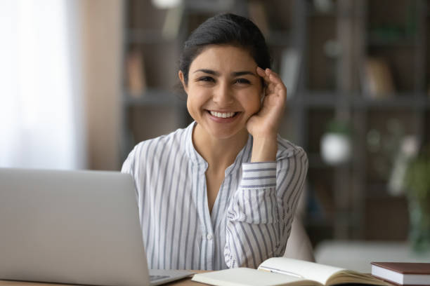 istock Smiling young mixed race woman employee posing by work desk 1333838148