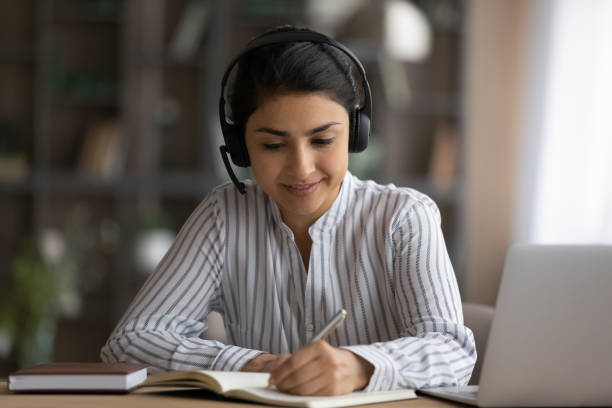 istock Busy millennial hindu female in wireless headset work using laptop 1333838151