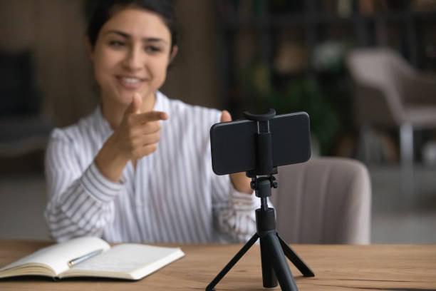istock Active young indian female shoot motivational training on cell webcam 1333838175