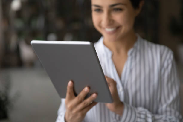 istock Happy young indian woman holding using modern tablet computer 1333838178