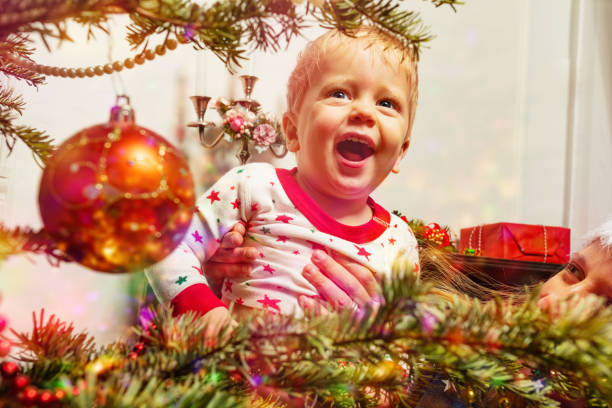 istock Laughing toddler cute boy by Christmas tree 1333838405