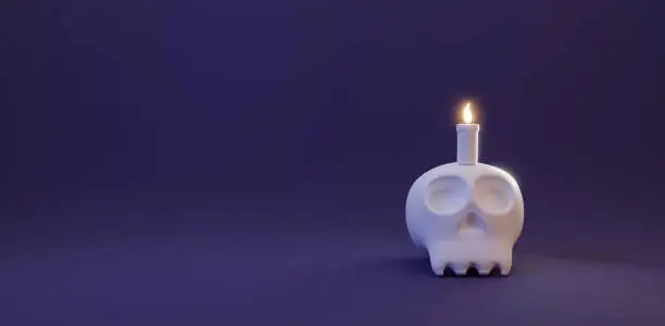 Photo of Halloween's day concept. Cute human skull with candle light on purple dark background, celebration Halloween event template minimal style