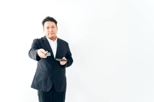 istock Men in suits paying by credit card 1333843909