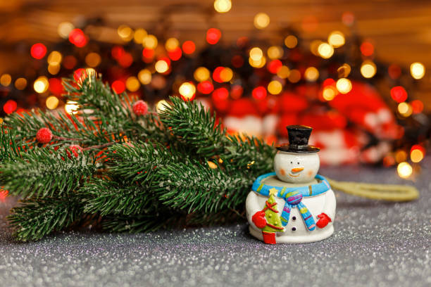 istock Christmas greeting card with snowman and Christmas tree. 1333852002